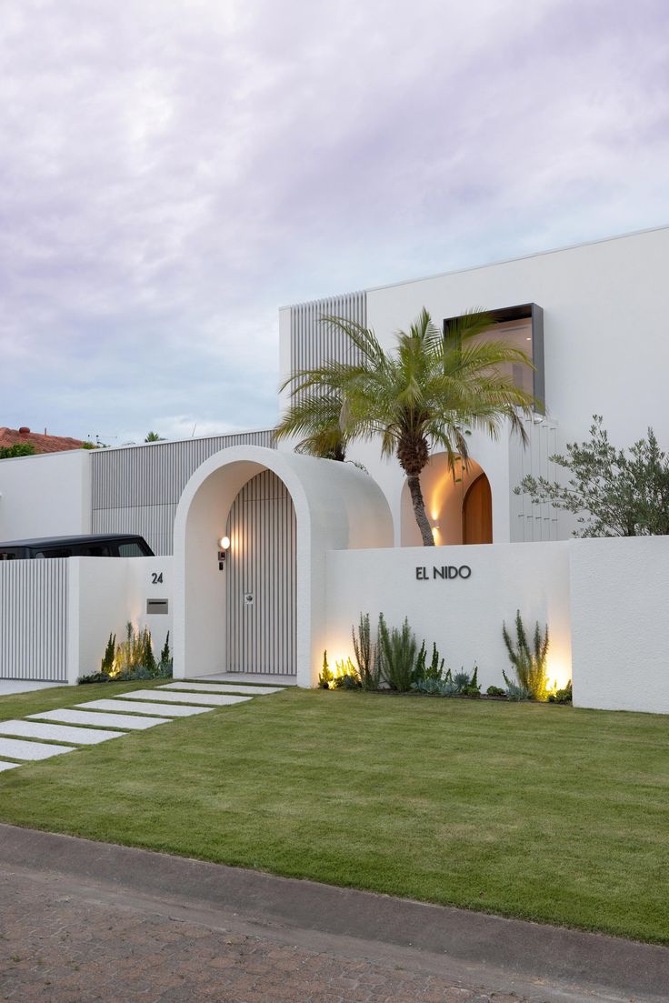 cute house, round entry gate, boundary wall ideas, wicked entry gate ideas, name plate ideas, house plan in different levels, metal windows, louver elevation, coloured louvers in elevation, arch pattern house, white house, house with lots of greenery, ludhiana, punjab